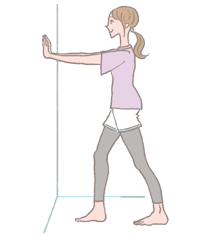 両手を壁に当て、片方の足を一歩下げる。